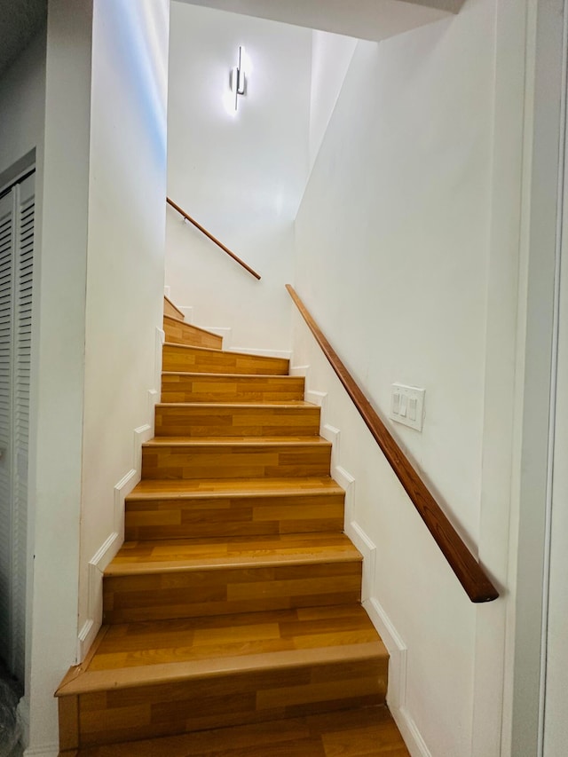 staircase with wood-type flooring