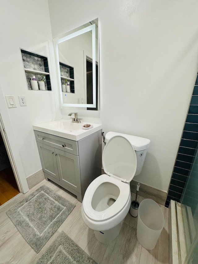 bathroom featuring vanity, toilet, and wood-type flooring