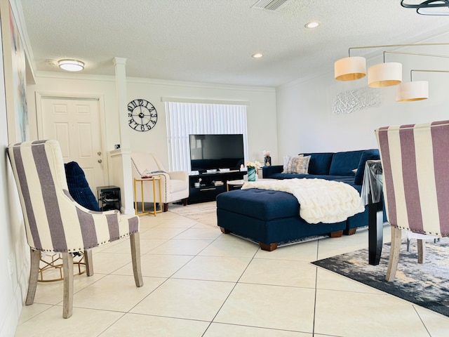 bedroom featuring crown molding, light tile patterned floors, and a textured ceiling