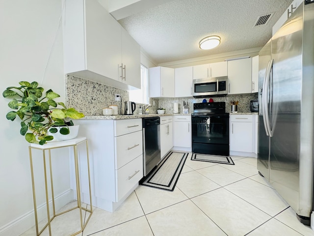 kitchen featuring decorative backsplash, a textured ceiling, stainless steel appliances, white cabinets, and light tile patterned flooring