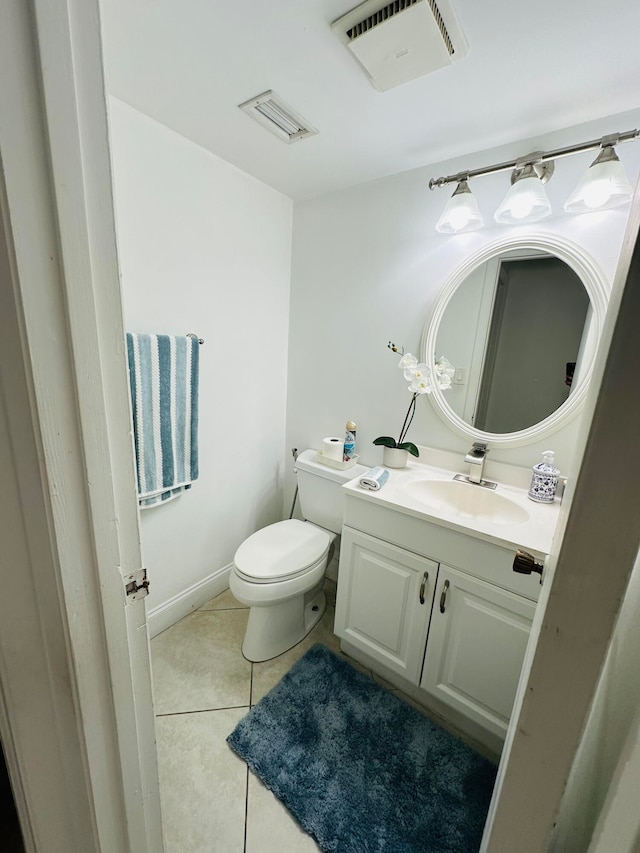 bathroom featuring tile patterned flooring, vanity, and toilet