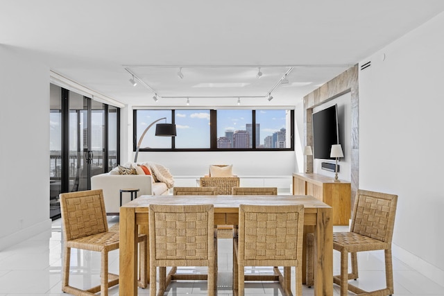 dining room featuring track lighting and light tile patterned floors