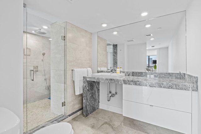 bathroom featuring walk in shower, vanity, and toilet