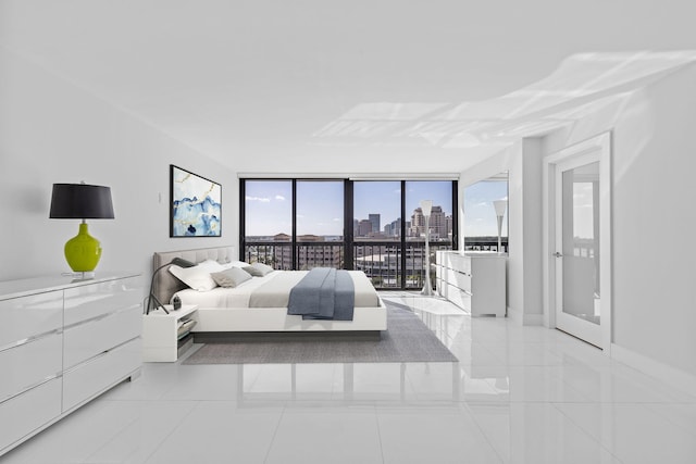 tiled bedroom featuring access to exterior and floor to ceiling windows