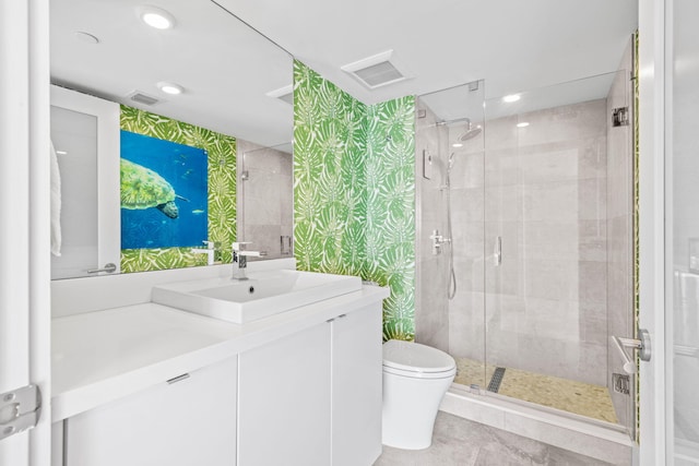 bathroom with tile patterned flooring, vanity, toilet, and an enclosed shower