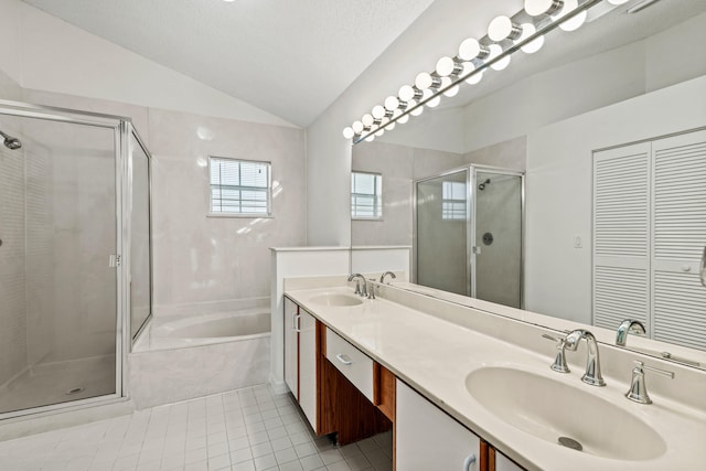 bathroom featuring a textured ceiling, vanity, plus walk in shower, tile patterned floors, and vaulted ceiling