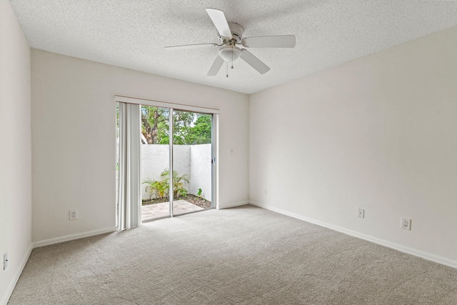 spare room with a textured ceiling, ceiling fan, and carpet floors