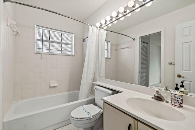 full bathroom featuring toilet, vanity, tile patterned floors, and shower / tub combo with curtain