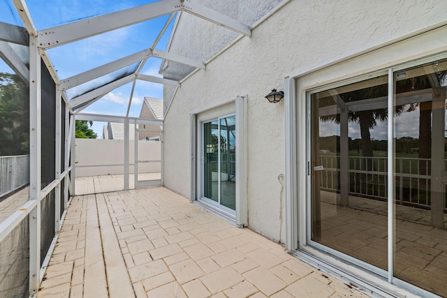 unfurnished sunroom featuring lofted ceiling