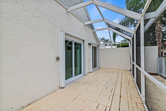 unfurnished sunroom featuring lofted ceiling