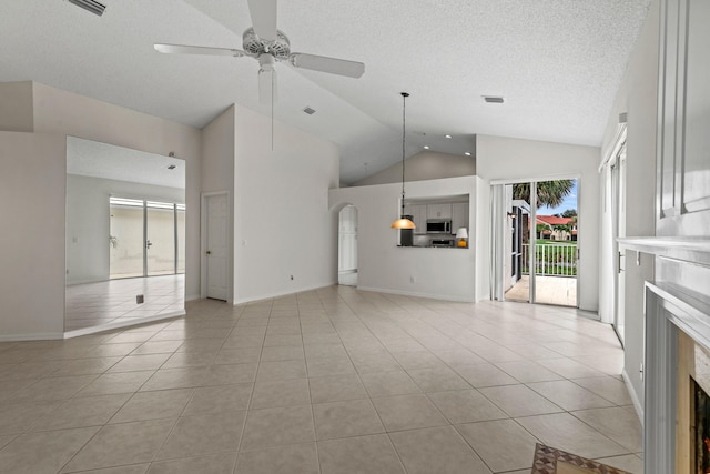 unfurnished living room featuring high vaulted ceiling, ceiling fan, light tile patterned flooring, and a fireplace