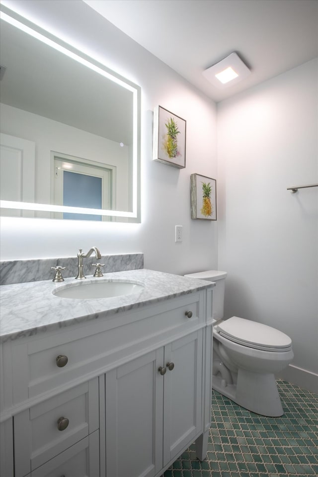 bathroom featuring vanity and toilet