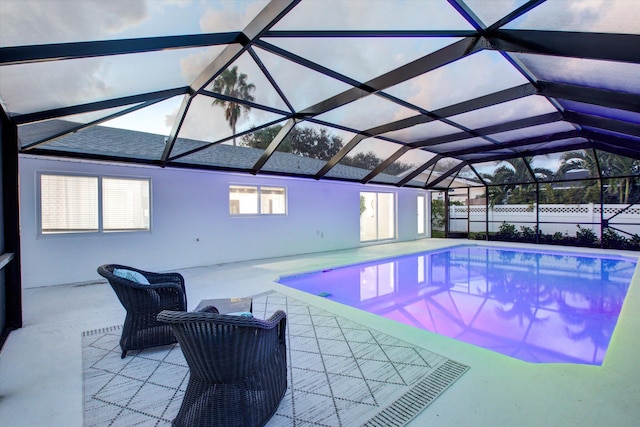 view of swimming pool featuring a lanai and a patio