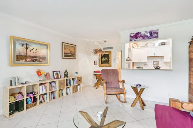 sitting room featuring crown molding and light tile patterned floors