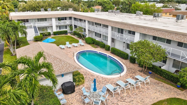 view of pool featuring cooling unit and a patio area