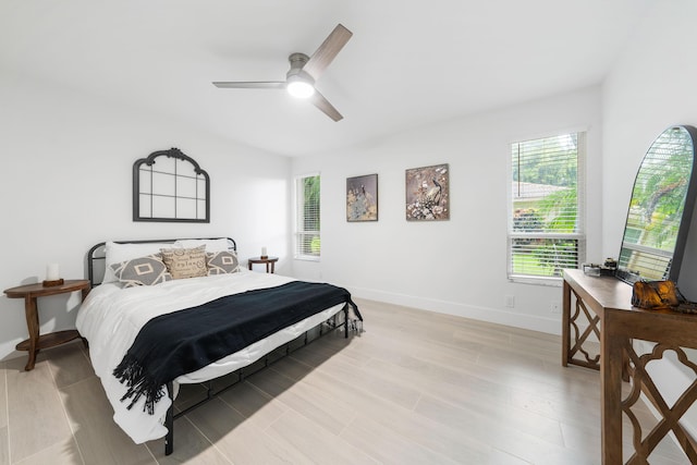 bedroom with ceiling fan and light hardwood / wood-style floors