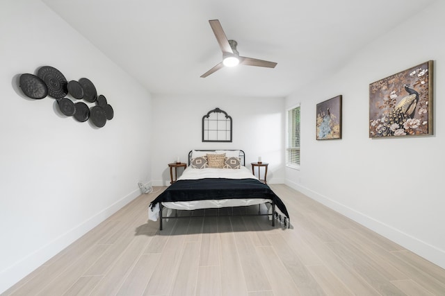 bedroom with light hardwood / wood-style floors and ceiling fan