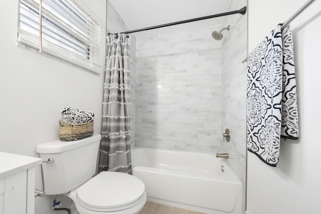 full bathroom featuring vanity, shower / bath combination with curtain, and toilet