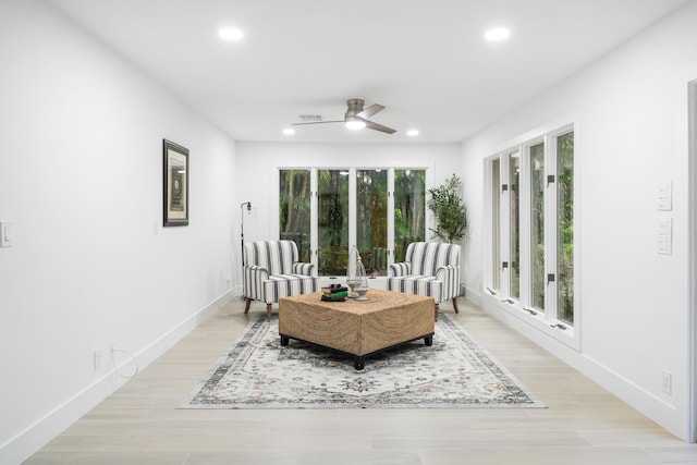 living area featuring ceiling fan and light wood-type flooring