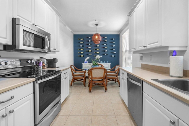 kitchen featuring white cabinetry, stainless steel appliances, ornamental molding, and pendant lighting