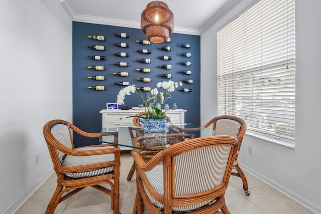 sitting room with ornamental molding and light tile patterned floors