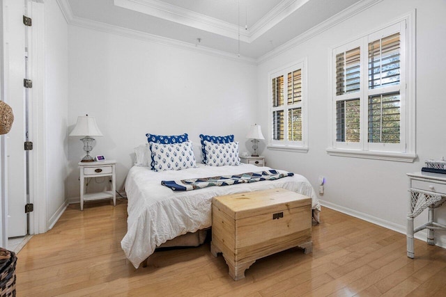 bedroom with multiple windows, hardwood / wood-style flooring, and crown molding