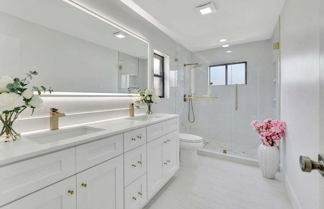 bathroom with vanity, toilet, and a shower with door