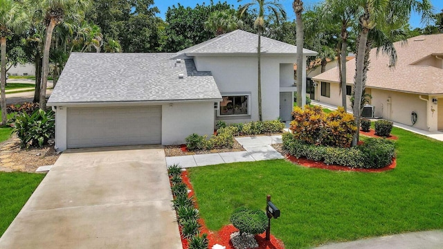 view of front of property with central AC unit, a garage, and a front lawn