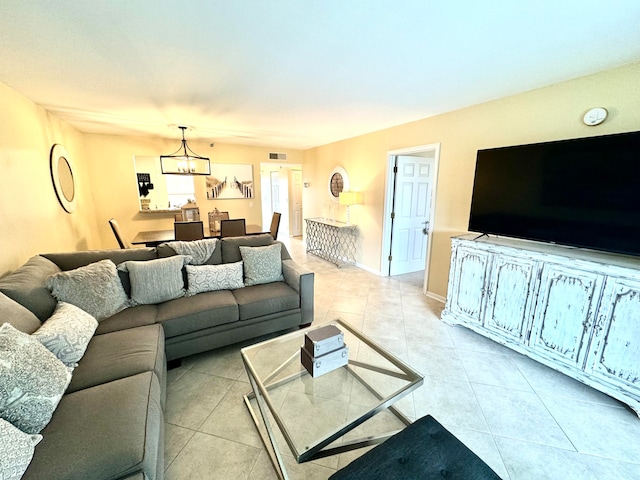 tiled living room with a chandelier