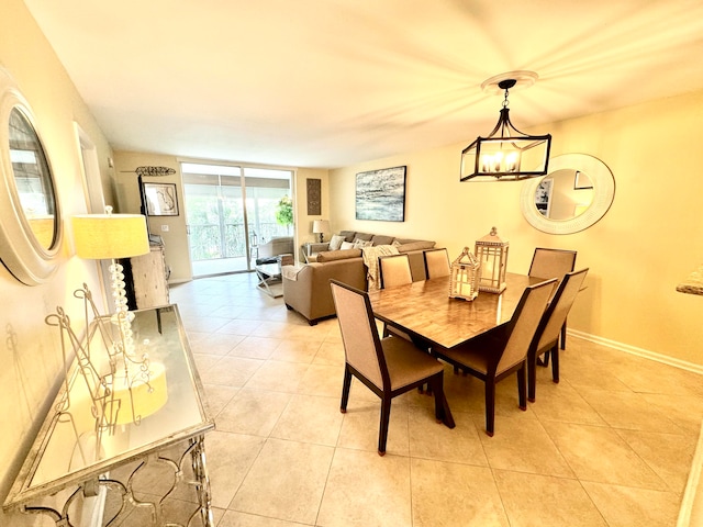 tiled dining space featuring a chandelier