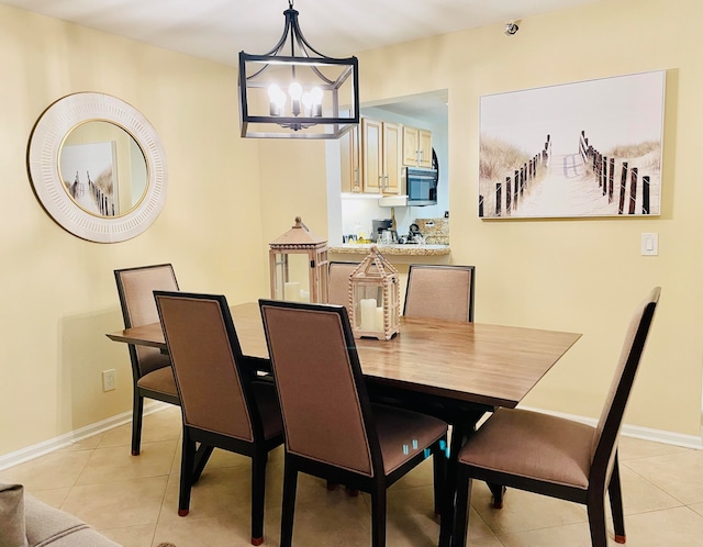 dining area with an inviting chandelier and light tile patterned floors