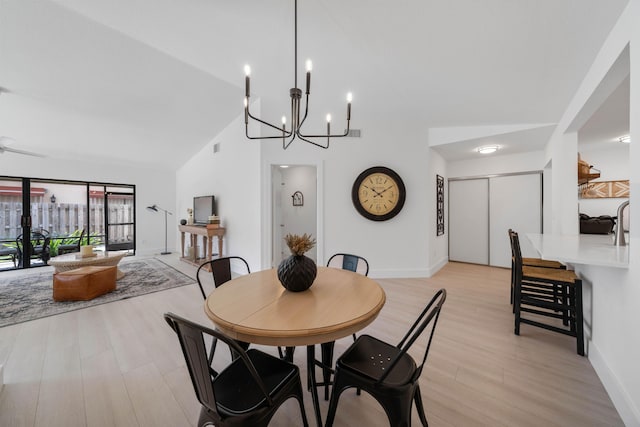 kitchen featuring white cabinetry, sink, light hardwood / wood-style flooring, a kitchen bar, and decorative backsplash