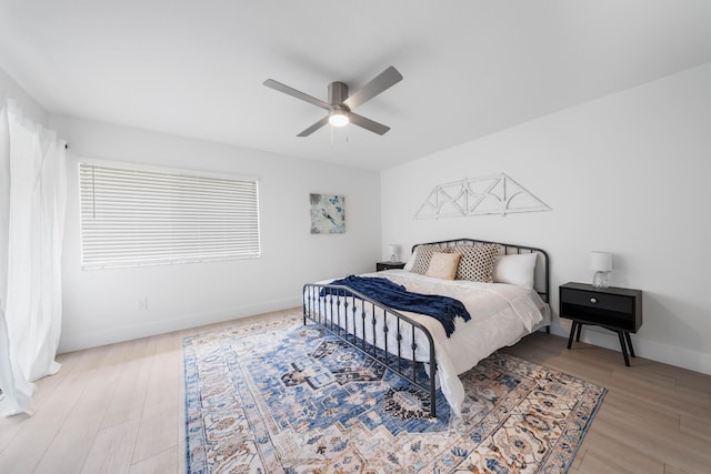 bedroom with ceiling fan and light hardwood / wood-style flooring