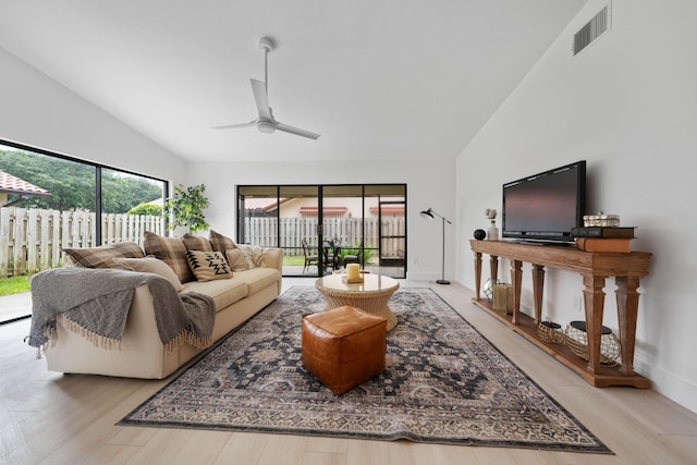 living room with high vaulted ceiling, light hardwood / wood-style flooring, and ceiling fan