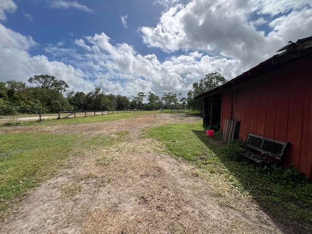 view of yard featuring an outbuilding and a rural view