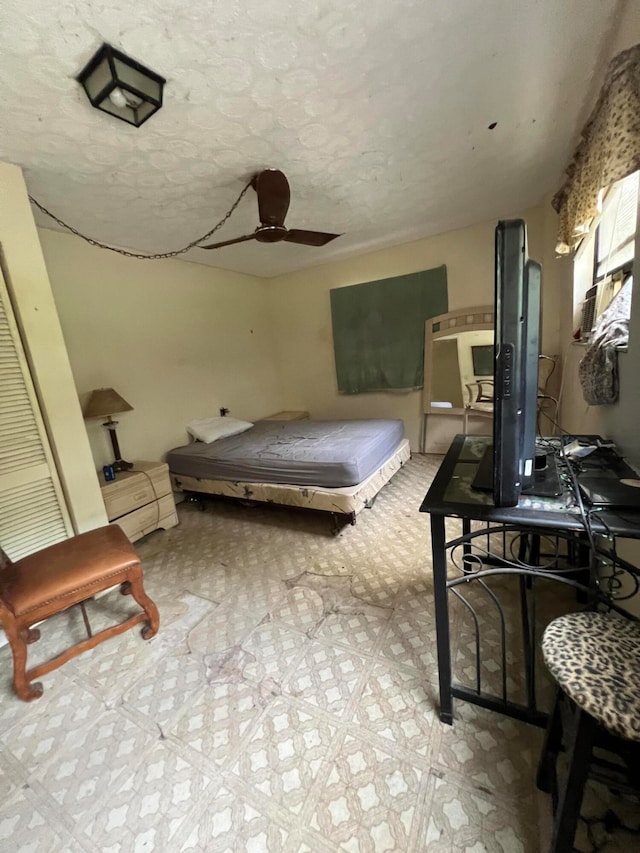 bedroom with a textured ceiling and ceiling fan