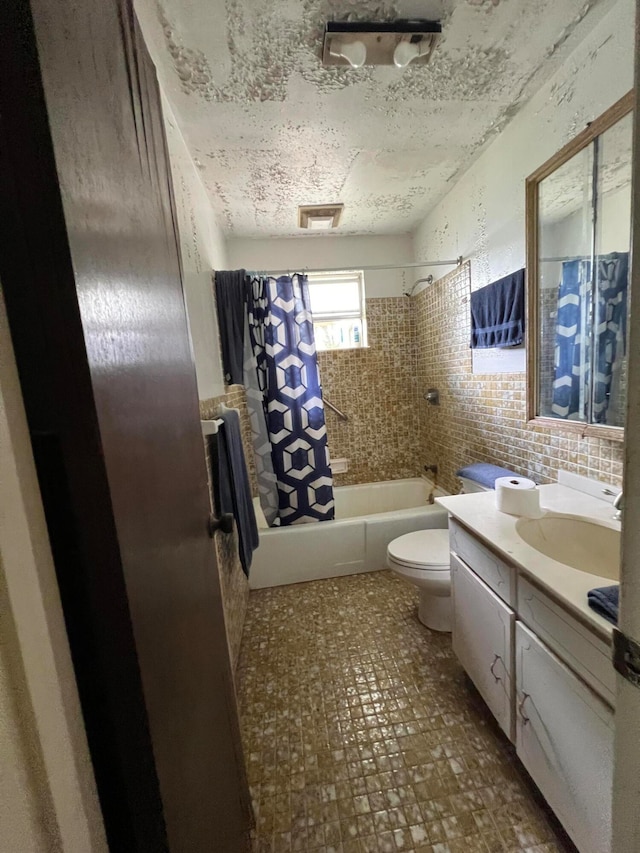 full bathroom featuring shower / bath combo, vanity, tasteful backsplash, and toilet