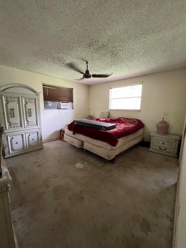 carpeted bedroom with ceiling fan and a textured ceiling