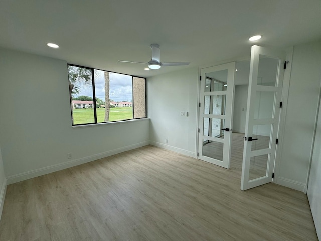 unfurnished bedroom featuring french doors, light wood-type flooring, and ceiling fan