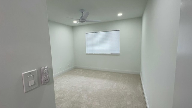 carpeted empty room featuring ceiling fan