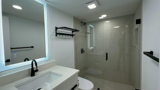 bathroom featuring vanity, an enclosed shower, and toilet