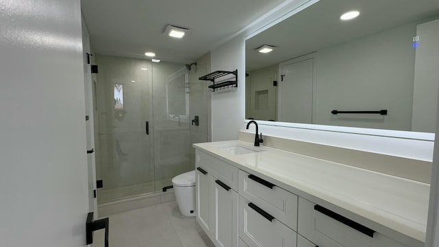 bathroom with vanity, tile patterned floors, toilet, and walk in shower