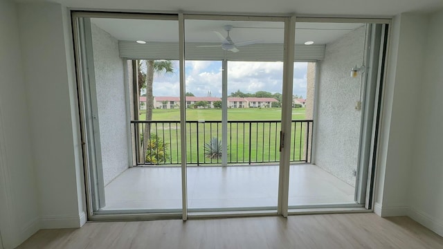 doorway to outside with light hardwood / wood-style floors and ceiling fan