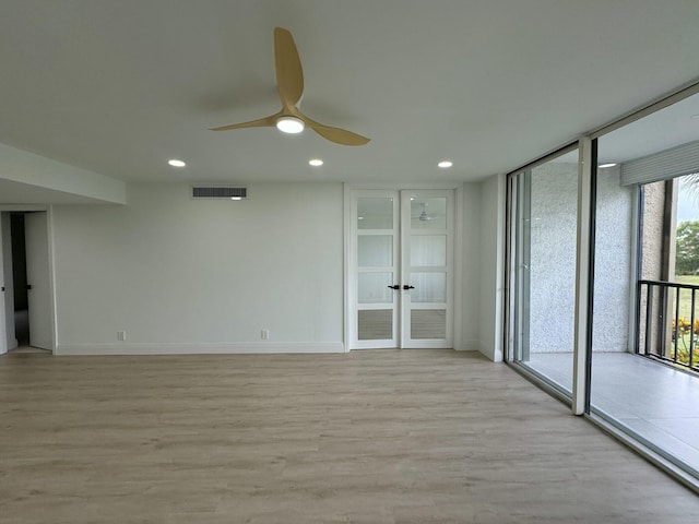 unfurnished room featuring french doors, ceiling fan, and light wood-type flooring