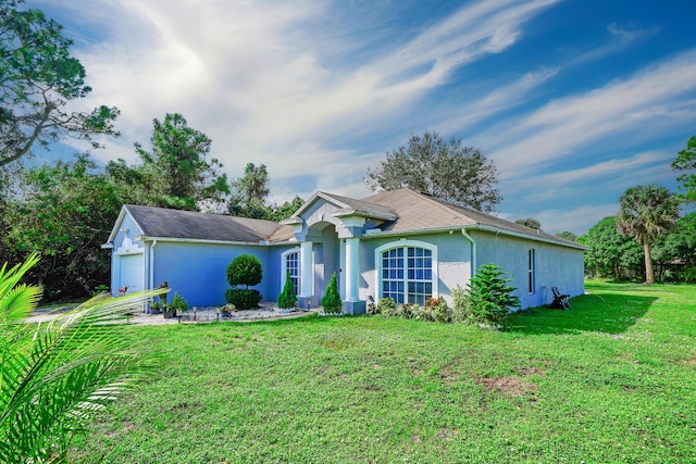 ranch-style house with a garage and a front lawn