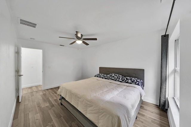 bedroom with light wood-type flooring and ceiling fan