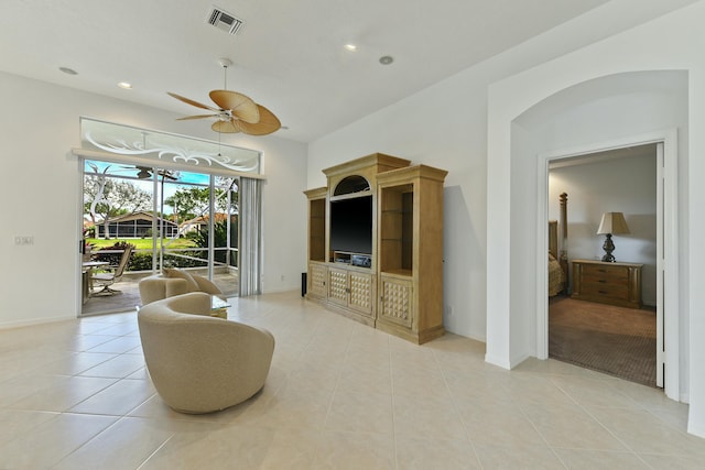 tiled living room featuring ceiling fan