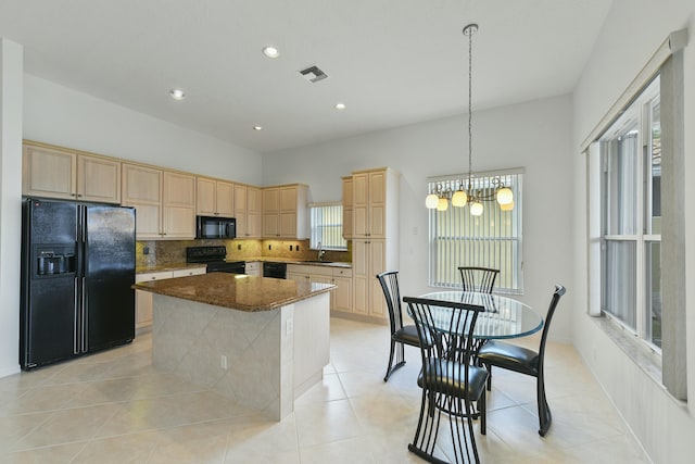 kitchen with sink, black appliances, light brown cabinets, a center island, and light tile patterned flooring