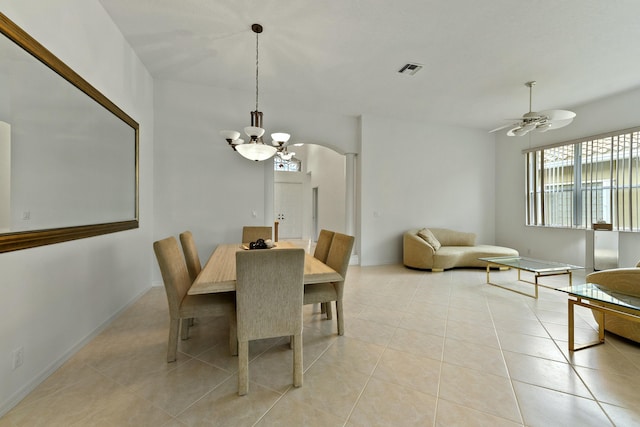 dining area featuring ceiling fan with notable chandelier and light tile patterned flooring