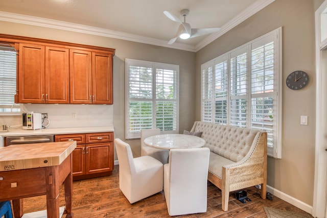 dining room with dark hardwood / wood-style flooring, ceiling fan, and ornamental molding